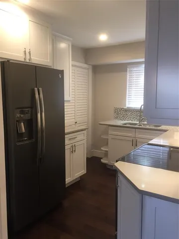 a kitchen with a refrigerator sink and stove