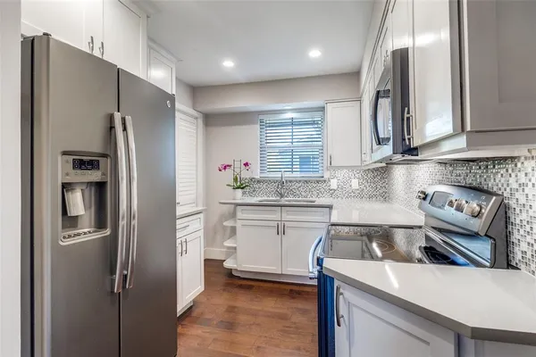 a kitchen with a refrigerator sink and stove