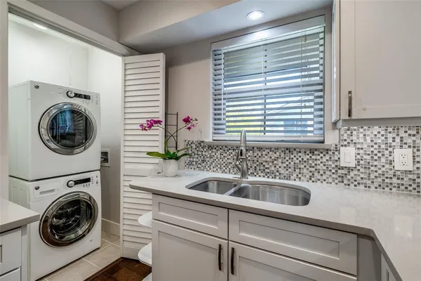 a close view of a sink and a washer in a room