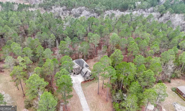 a view of empty room with wooden floor fan and window