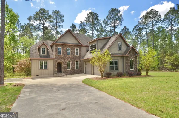a front view of house with yard and green space
