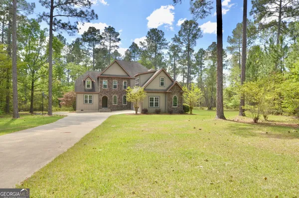 a front view of a house with a garden
