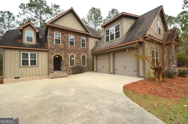 an aerial view of a house with lots of trees