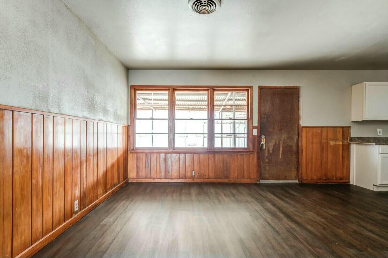 4407 49th Street Lubbock, TX 79414 - Photo 11 of 23 wooden floor in an empty room with a window