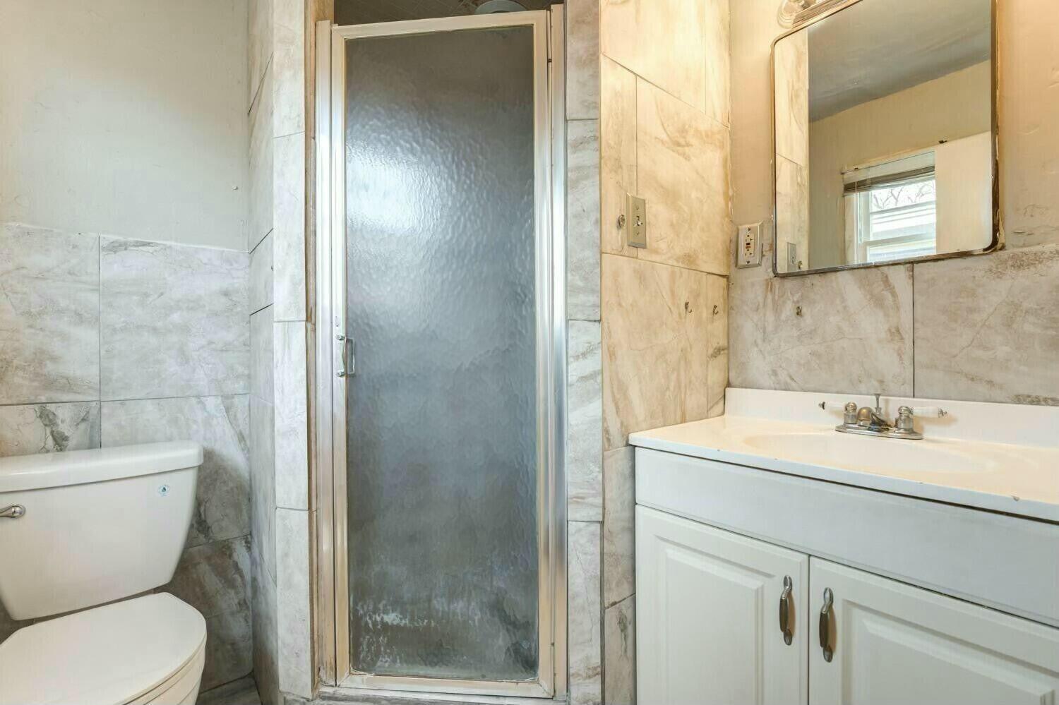 4407 49th Street Lubbock, TX 79414 - Photo 16 of 23 a bathroom with a toilet sink and shower