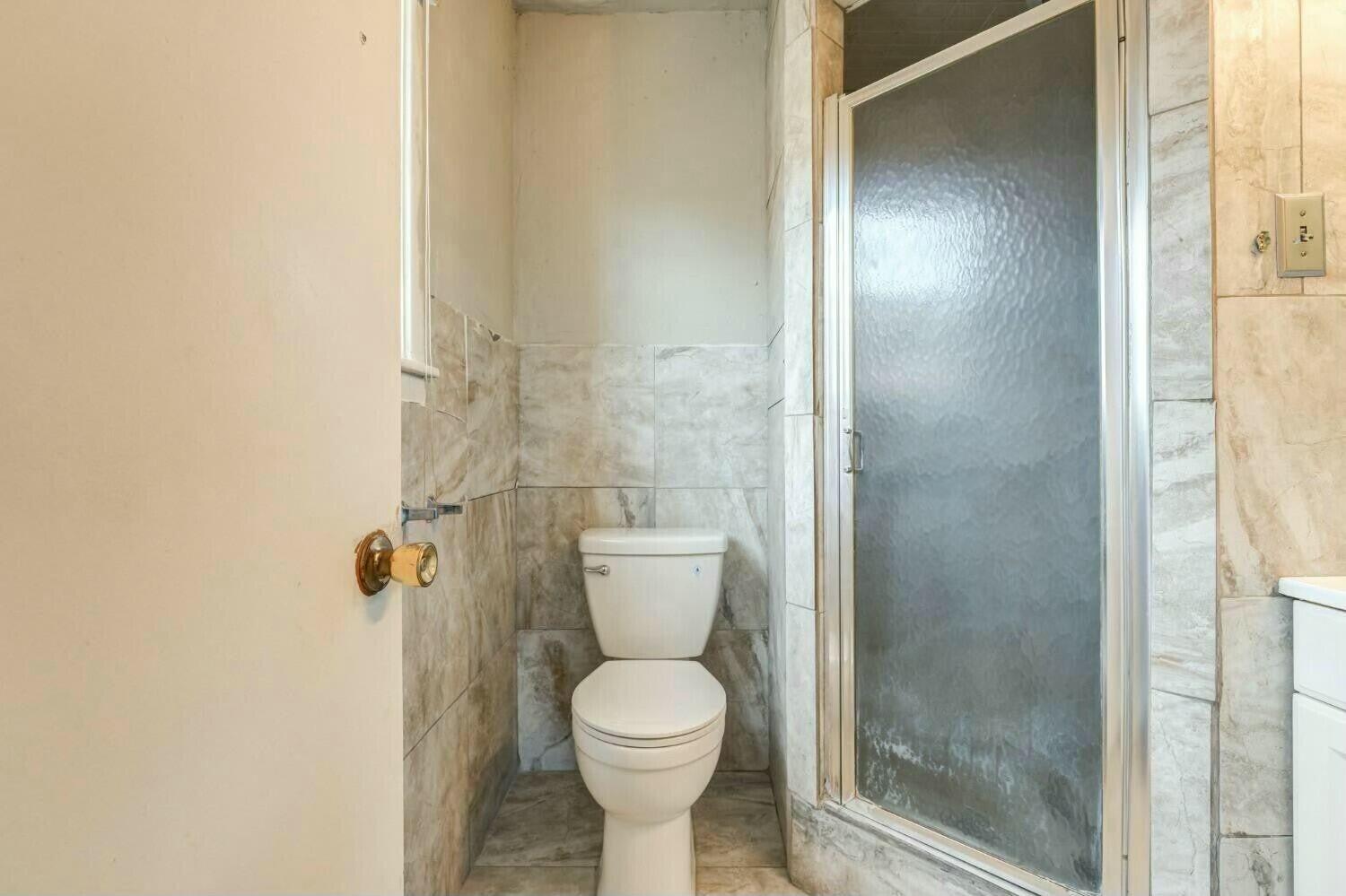 4407 49th Street Lubbock, TX 79414 - Photo 17 of 23 a bathroom with a toilet and a shower