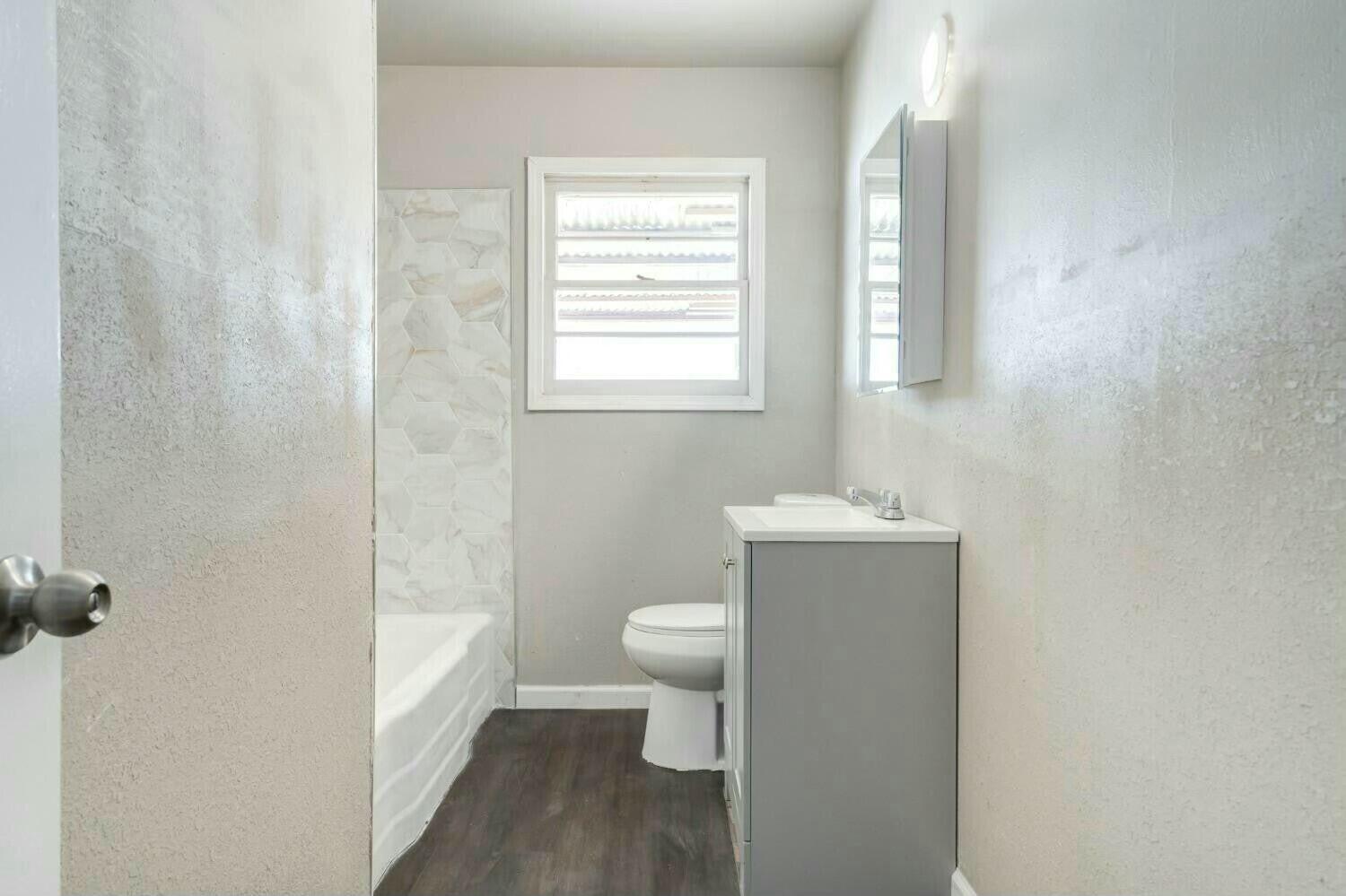 4407 49th Street Lubbock, TX 79414 - Photo 20 of 23 a bathroom with a toilet and a sink