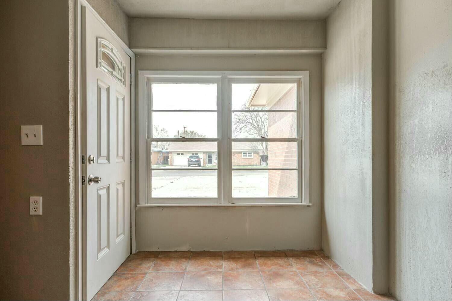 4407 49th Street Lubbock, TX 79414 - Photo 3 of 23 a view of an empty room with a window