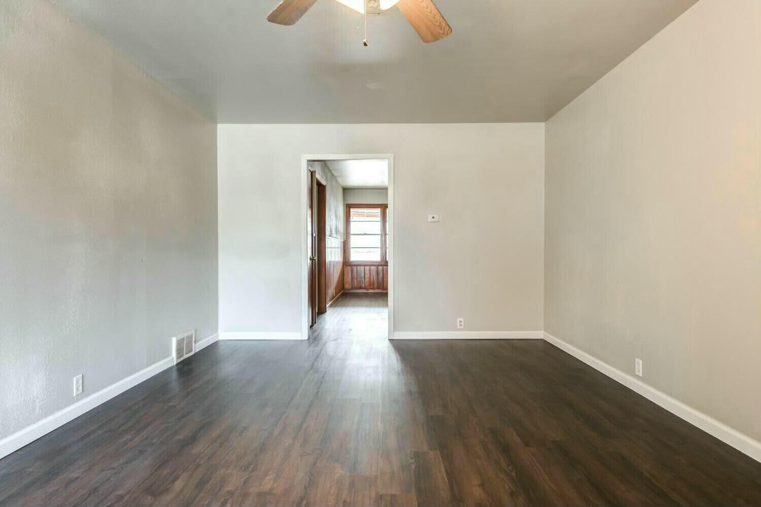 4407 49th Street Lubbock, TX 79414 - Photo 4 of 23 a view of a hallway with wooden floor
