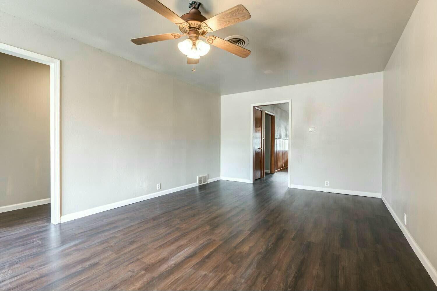 4407 49th Street Lubbock, TX 79414 - Photo 5 of 23 a view of an empty room with wooden floor