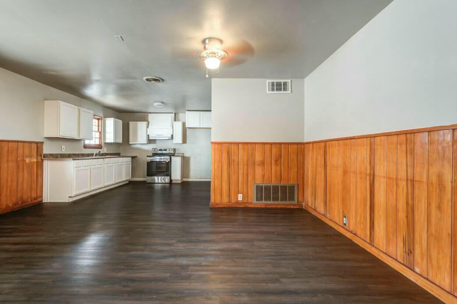 4407 49th Street Lubbock, TX 79414 - Photo 7 of 23 a view of kitchen with wooden floor and electronic appliances