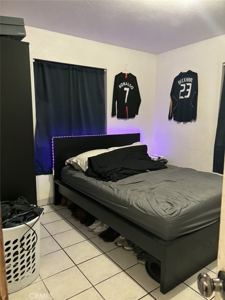 6911 Compton Avenue Los Angeles, CA 90001 - Photo 18 of 34 a bed sitting in a bedroom and dressers