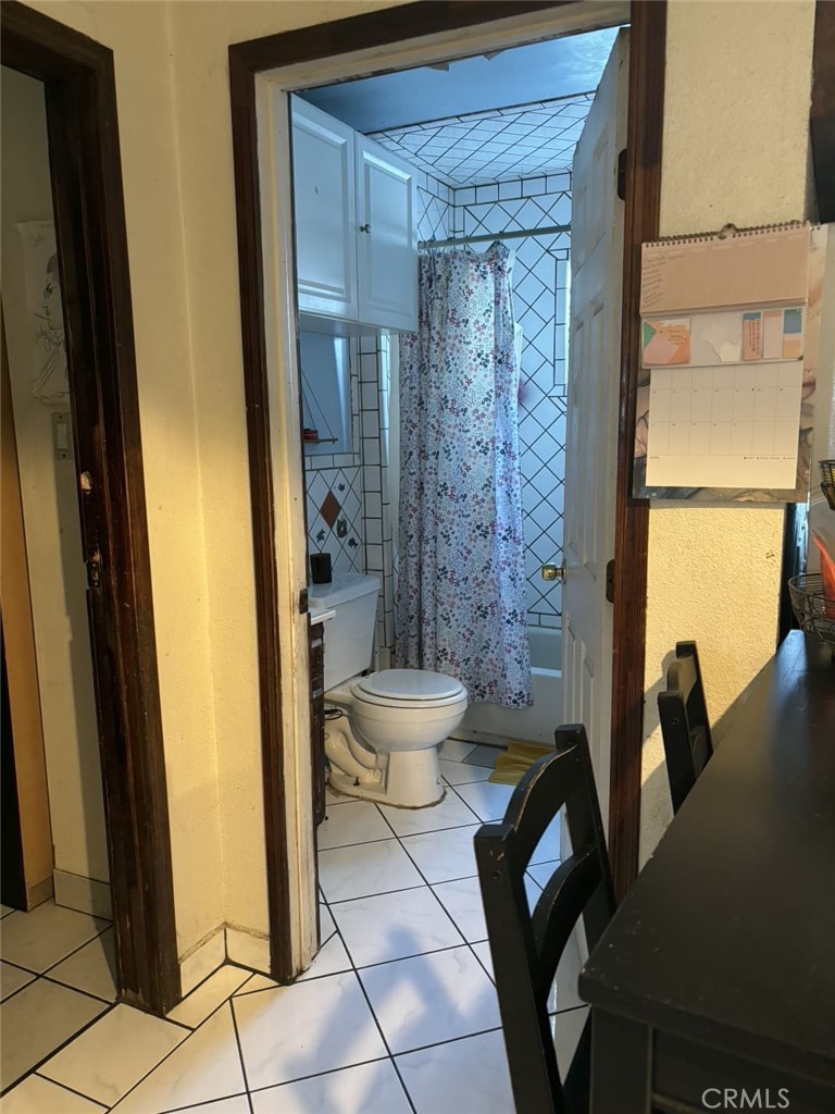 6911 Compton Avenue Los Angeles, CA 90001 - Photo 22 of 34 a bathroom with a toilet and a shower