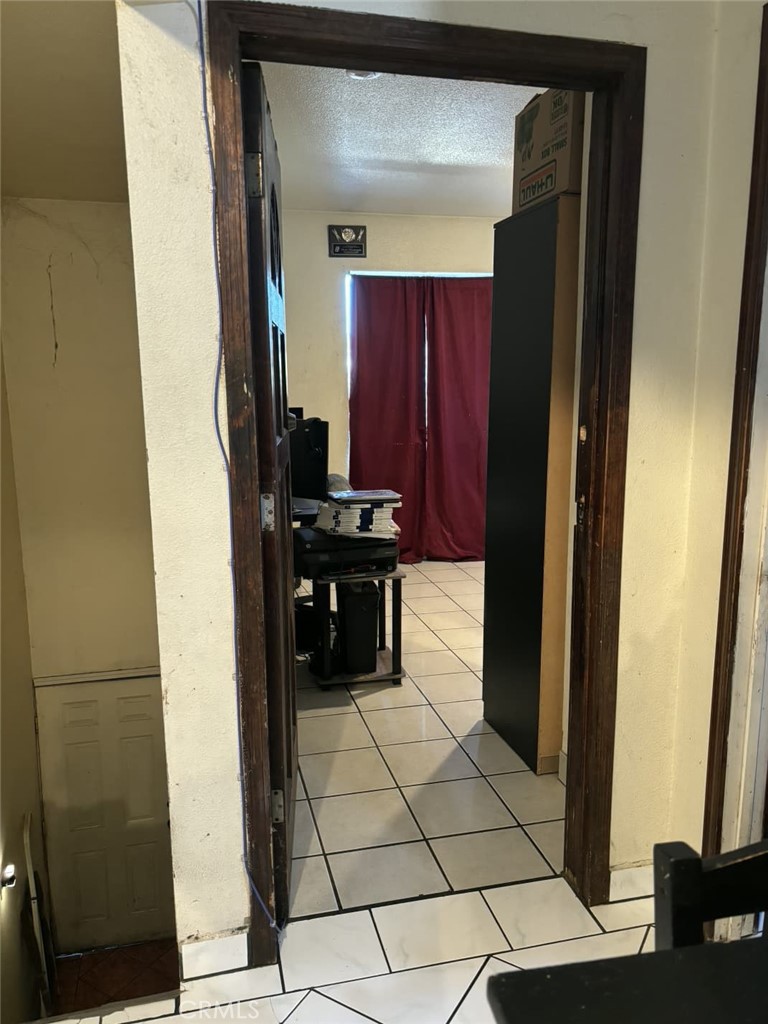 6911 Compton Avenue Los Angeles, CA 90001 - Photo 25 of 34 a kitchen with stainless steel appliances granite countertop a refrigerator and a stove