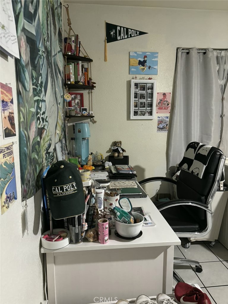 6911 Compton Avenue Los Angeles, CA 90001 - Photo 33 of 34 a view of a workspace with furniture and clutter