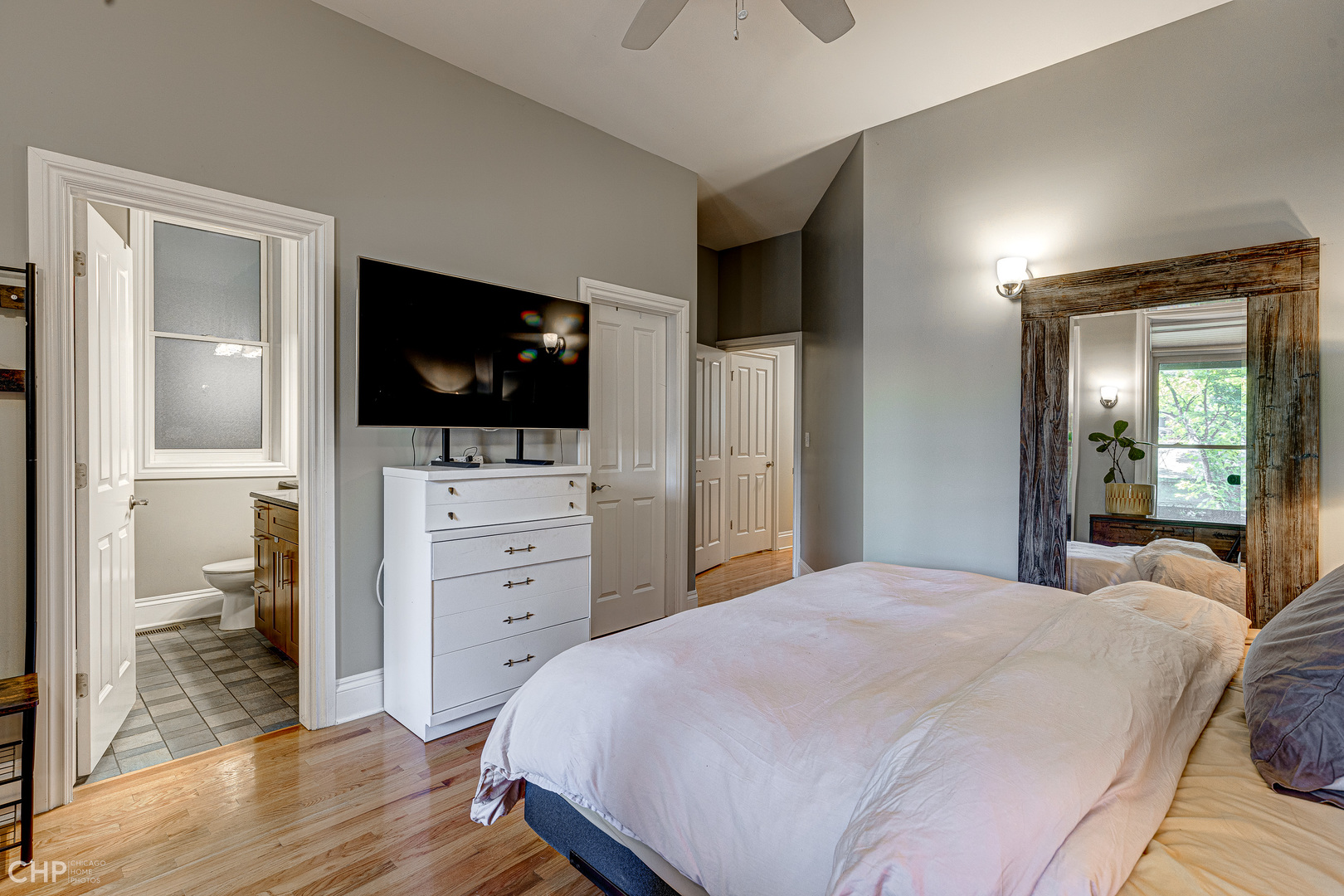 2116 West Potomac Avenue, Unit 1 Chicago, IL 60622 - Photo 13 of 24 a large bedroom with a bed and a flat screen tv