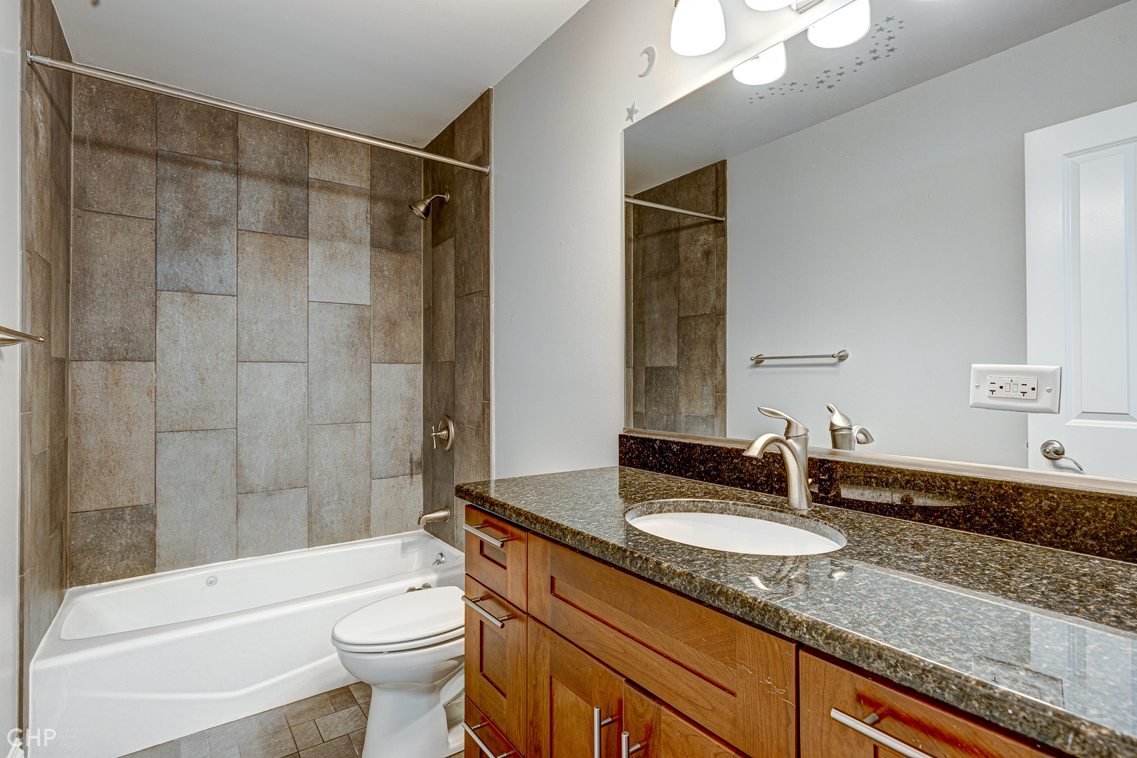 2116 West Potomac Avenue, Unit 1 Chicago, IL 60622 - Photo 20 of 24 a bathroom with a granite countertop sink toilet mirror and shower