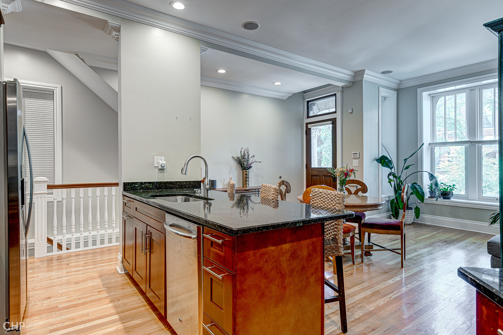2116 West Potomac Avenue, Unit 1 Chicago, IL 60622 - Photo 7 of 24 a view of a kitchen area with furniture and wooden floor