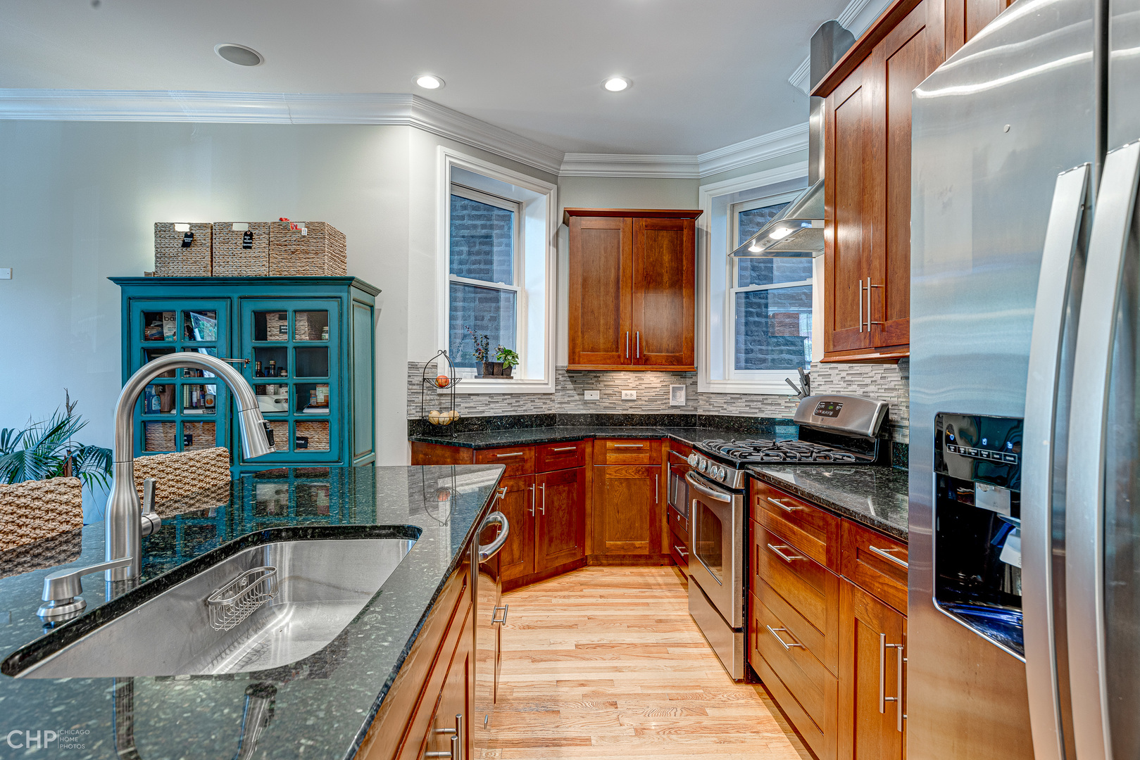 2116 West Potomac Avenue, Unit 1 Chicago, IL 60622 - Photo 9 of 24 a kitchen with stainless steel appliances granite countertop a sink a stove and a refrigerator