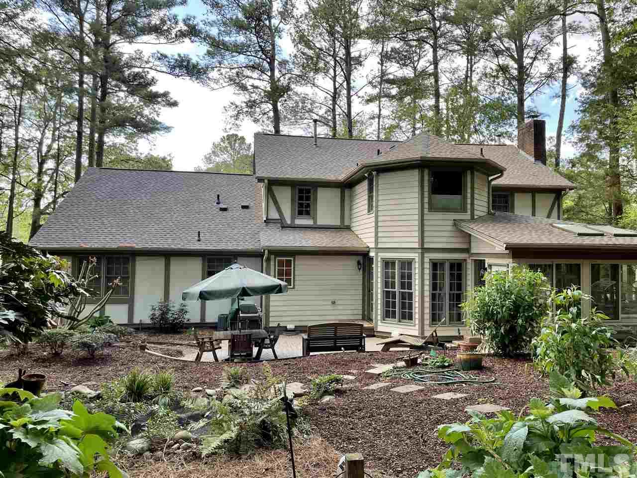 7804 Harps Mill Road Raleigh, NC 27615 - Photo 3 of 3 a backyard of a house with yard fire pit and outdoor seating