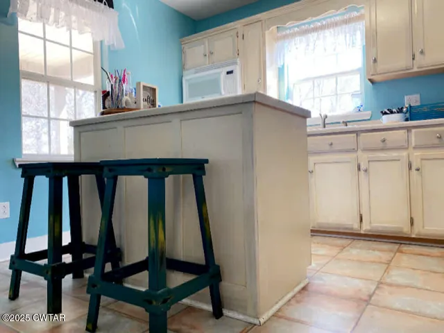 a kitchen with stainless steel appliances a stove a refrigerator and a cabinets