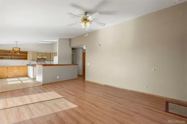 a view of a kitchen with wooden floor and a kitchen