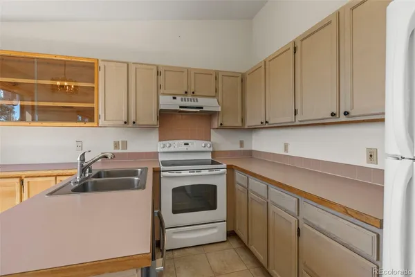 a kitchen with a sink and a stove top oven