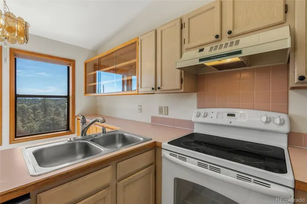 a kitchen with a stove and a sink