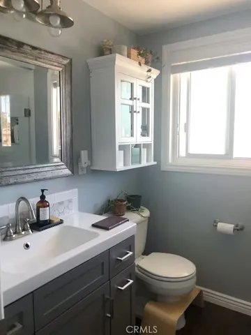 a bathroom with a sink toilet and a mirror