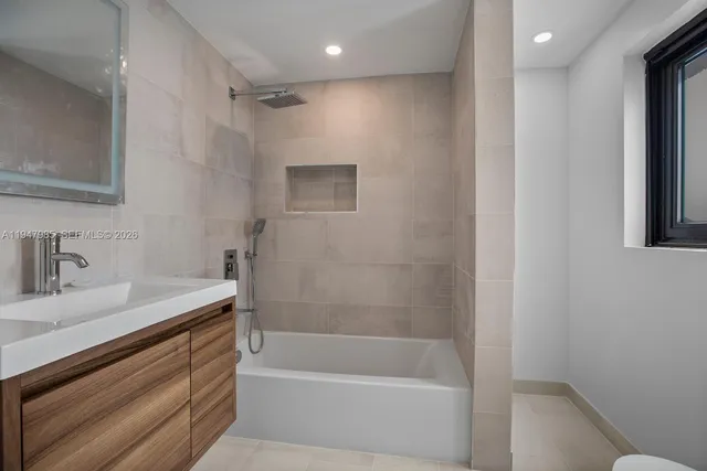 a bathroom with a bathtub and a sink