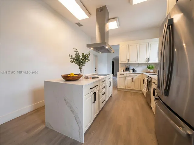 a kitchen with stainless steel appliances a white stove top oven and a refrigerator