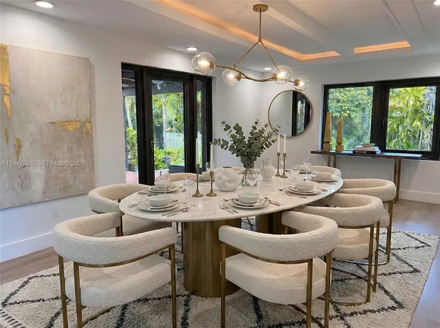 a dining room with furniture a window and a chandelier
