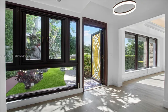 a view of a room that has a floor to ceiling window and an outdoor view