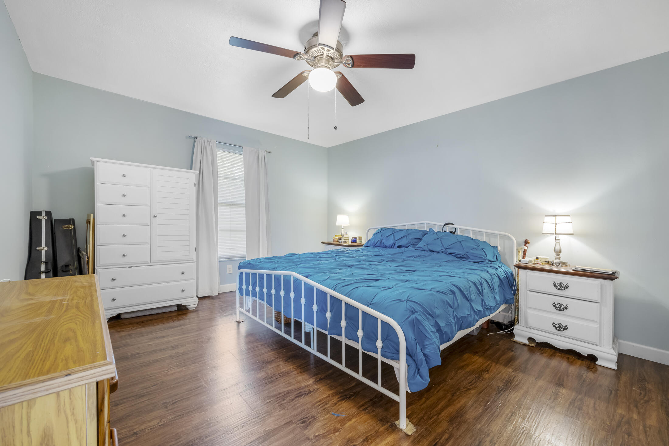 938 Cherokee Road Southeast Palm Bay, FL 32909 - Photo 12 of 29 a bedroom with a bed and wooden floor