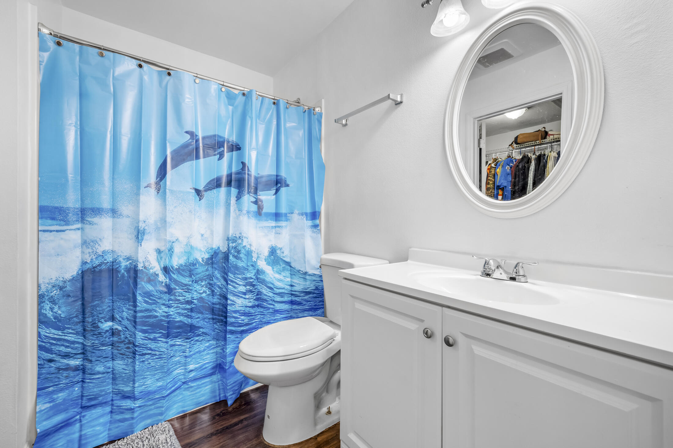 938 Cherokee Road Southeast Palm Bay, FL 32909 - Photo 14 of 29 a bathroom with a toilet a sink and mirror