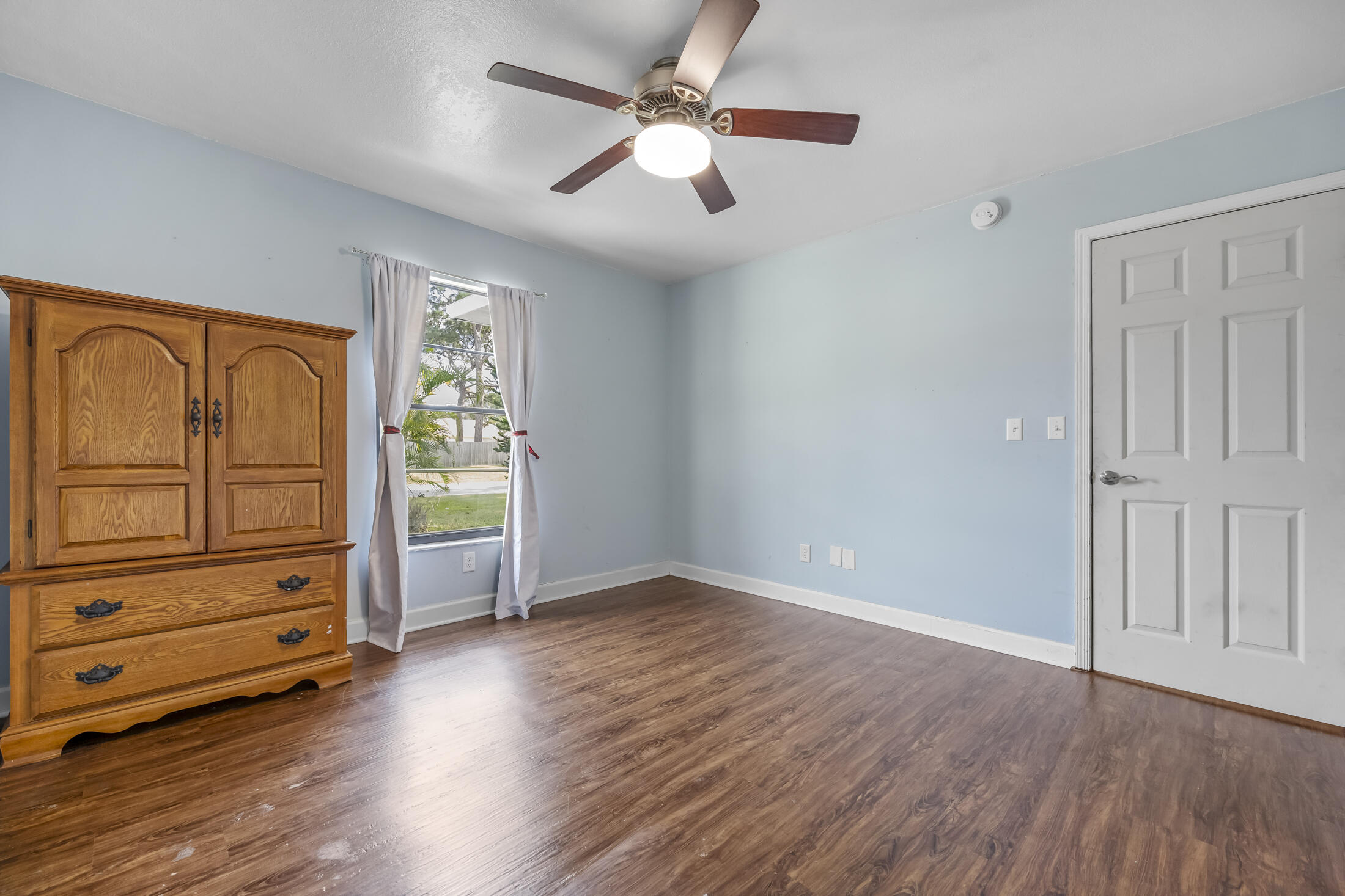 938 Cherokee Road Southeast Palm Bay, FL 32909 - Photo 16 of 29 wooden floor in an empty room with a window