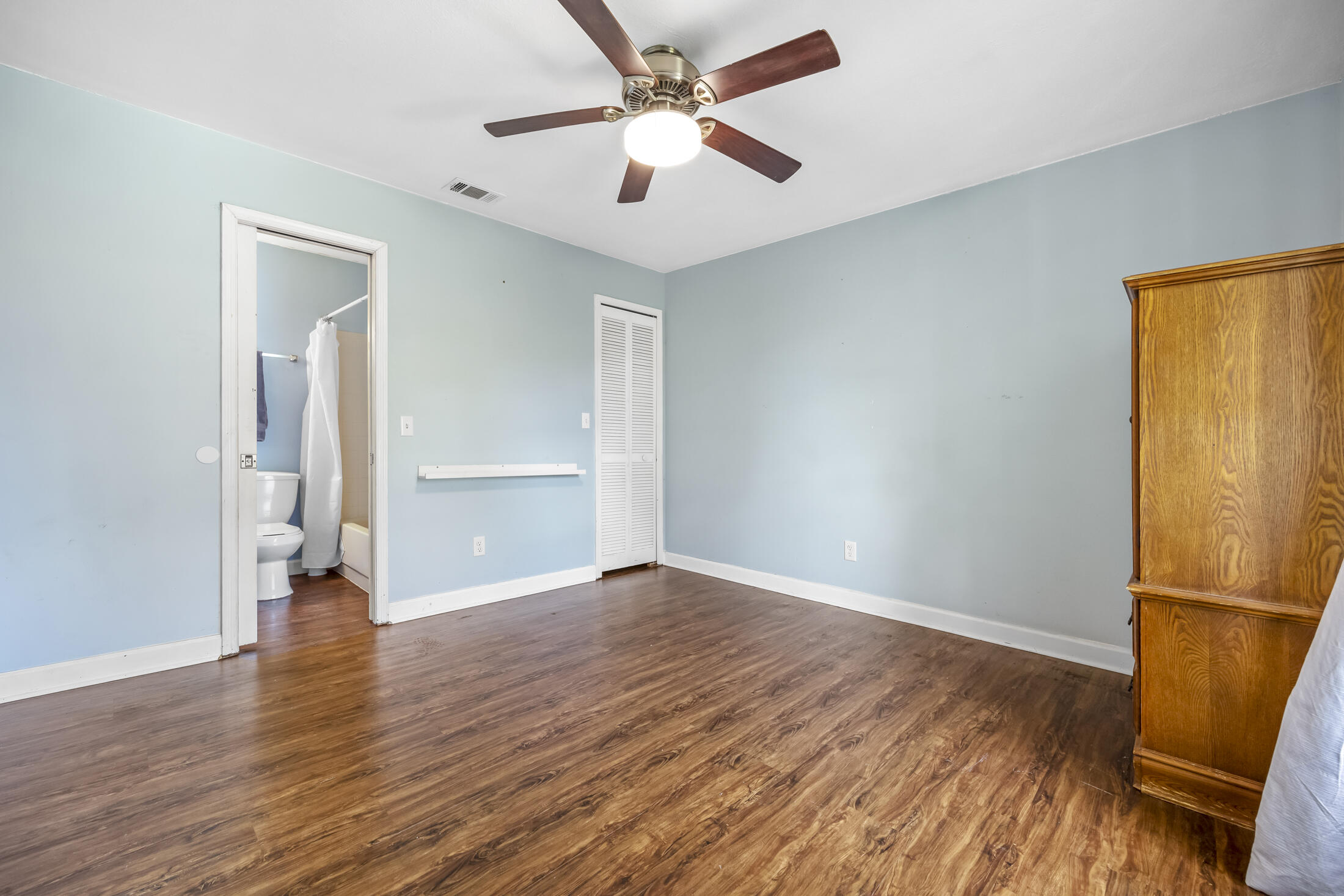 938 Cherokee Road Southeast Palm Bay, FL 32909 - Photo 17 of 29 an empty room with wooden floor and a ceiling fan