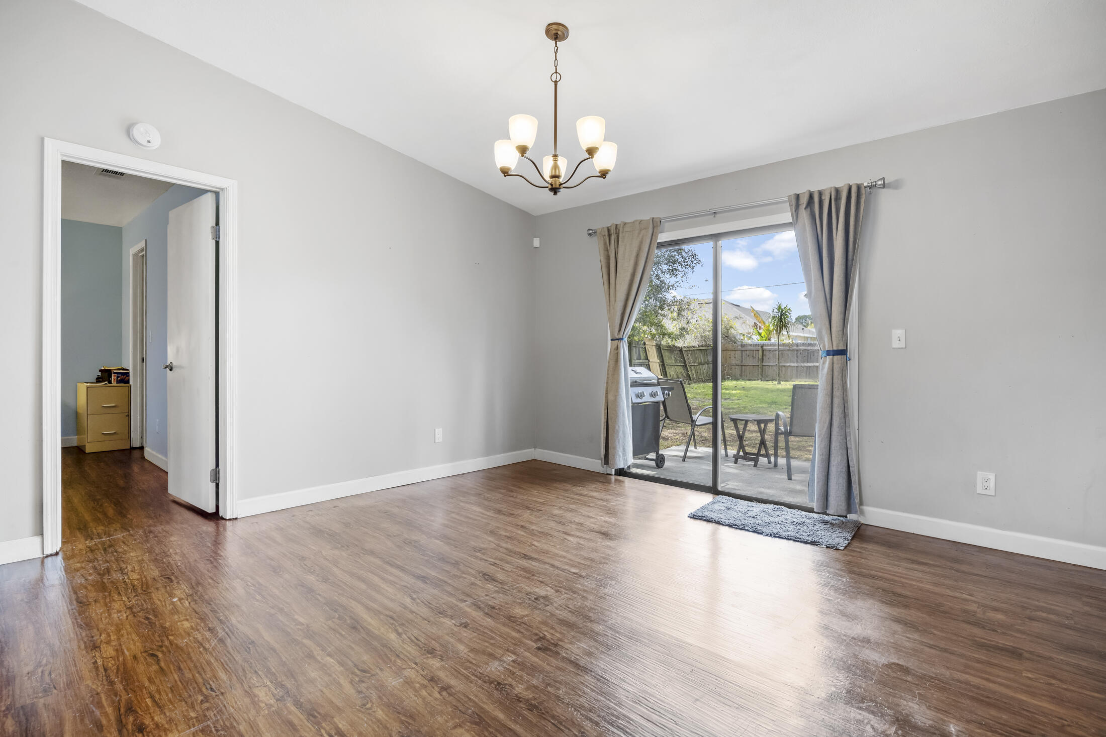 938 Cherokee Road Southeast Palm Bay, FL 32909 - Photo 20 of 29 a view of an empty room with wooden floor and a window