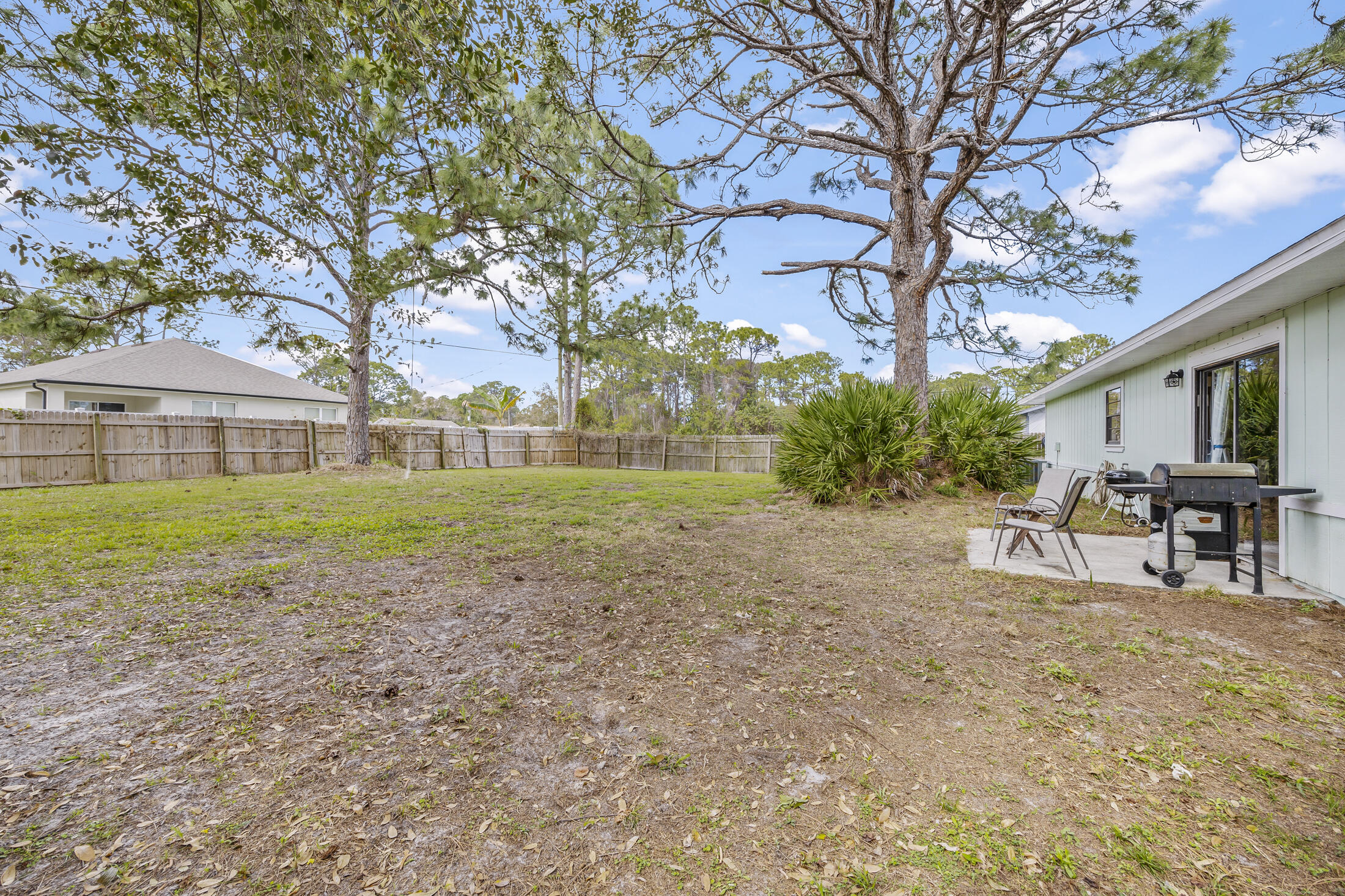 938 Cherokee Road Southeast Palm Bay, FL 32909 - Photo 24 of 29 a view of house with backyard and trees