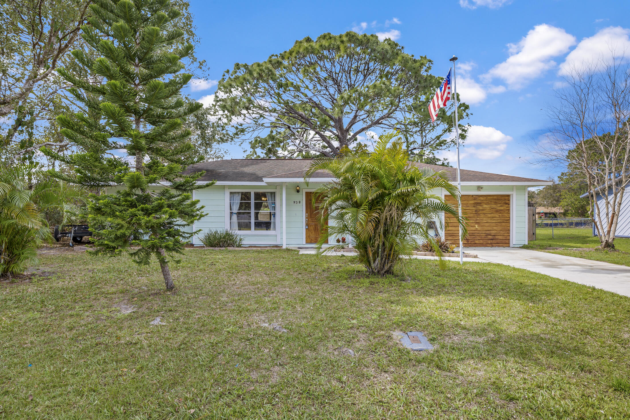 938 Cherokee Road Southeast Palm Bay, FL 32909 - Photo 3 of 29 a view of a house with a tree and a yard