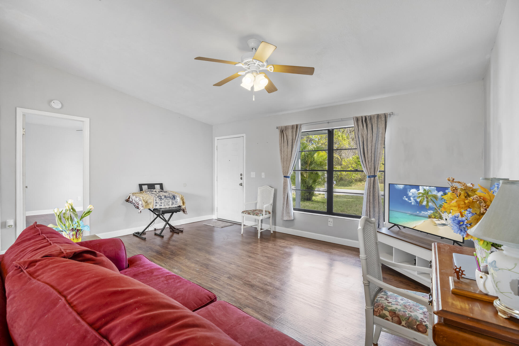 938 Cherokee Road Southeast Palm Bay, FL 32909 - Photo 6 of 29 a living room with furniture and a chandelier