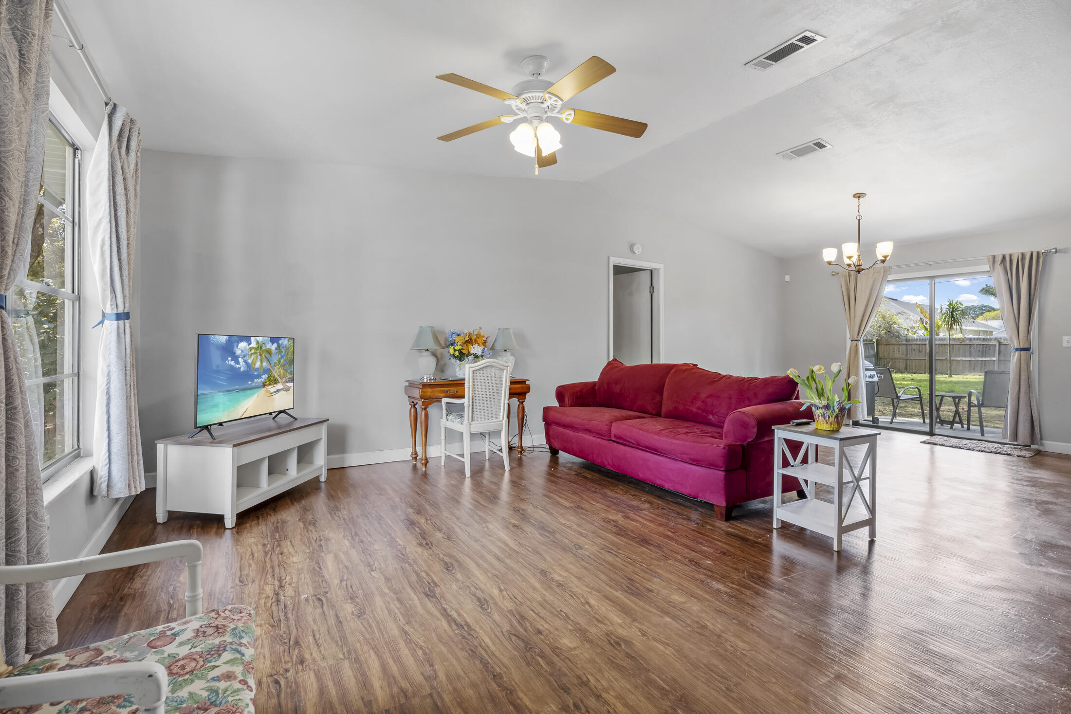 938 Cherokee Road Southeast Palm Bay, FL 32909 - Photo 7 of 29 a living room with furniture and a wooden floor