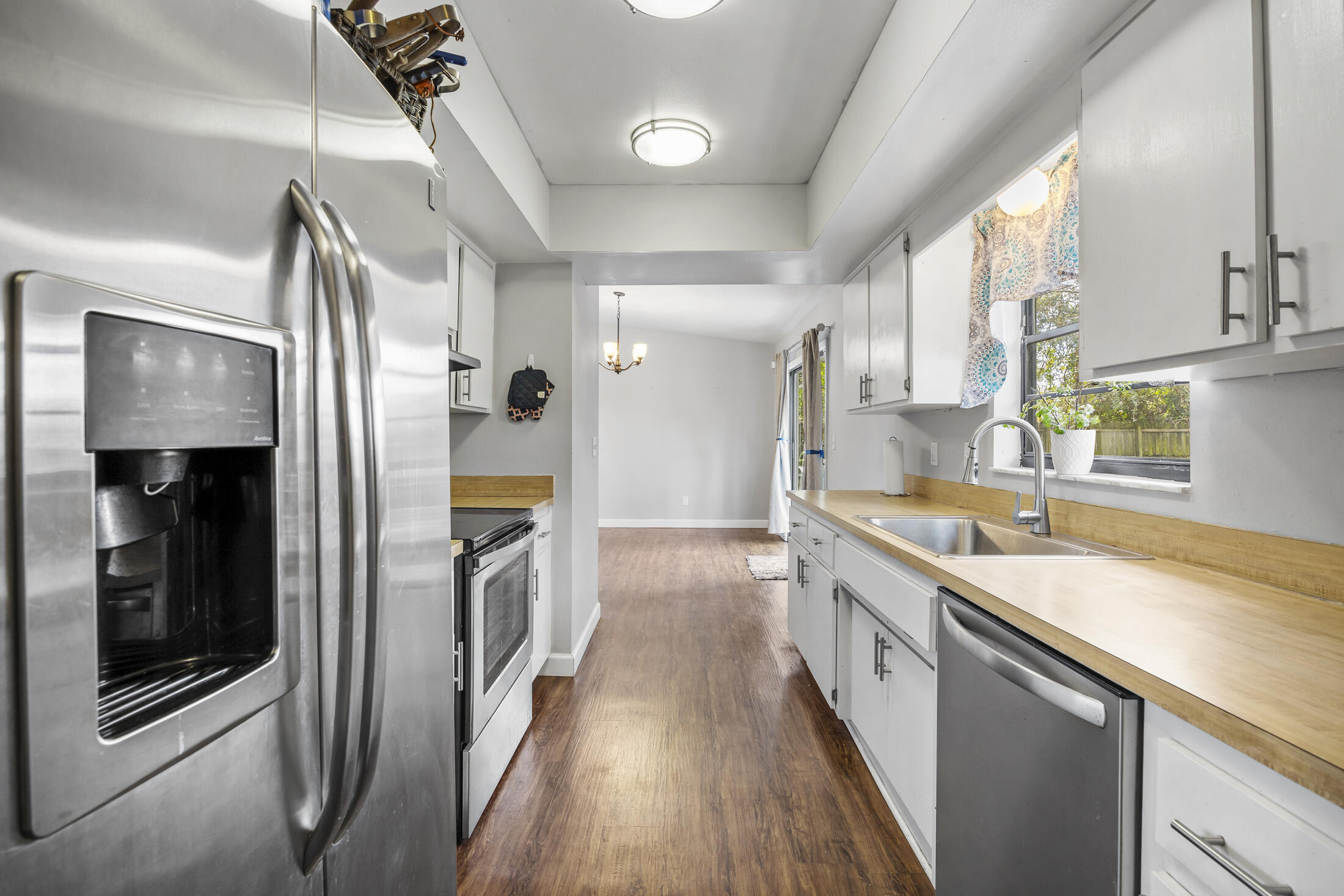 938 Cherokee Road Southeast Palm Bay, FL 32909 - Photo 10 of 29 a kitchen with a sink and a refrigerator