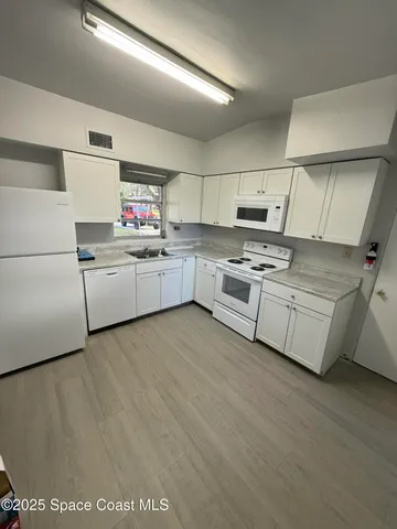 a kitchen with appliances cabinets and a sink