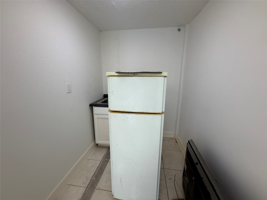 5914 Cullen Boulevard Houston, TX 77021 - Photo 9 of 16 a view of a storage & utility room with a refrigerator