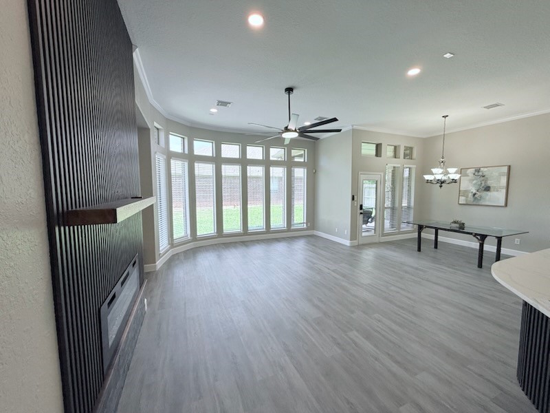 7218 Spring Meadow Lane Katy, TX 77494 - Photo 14 of 30 an empty room with wooden floor and windows