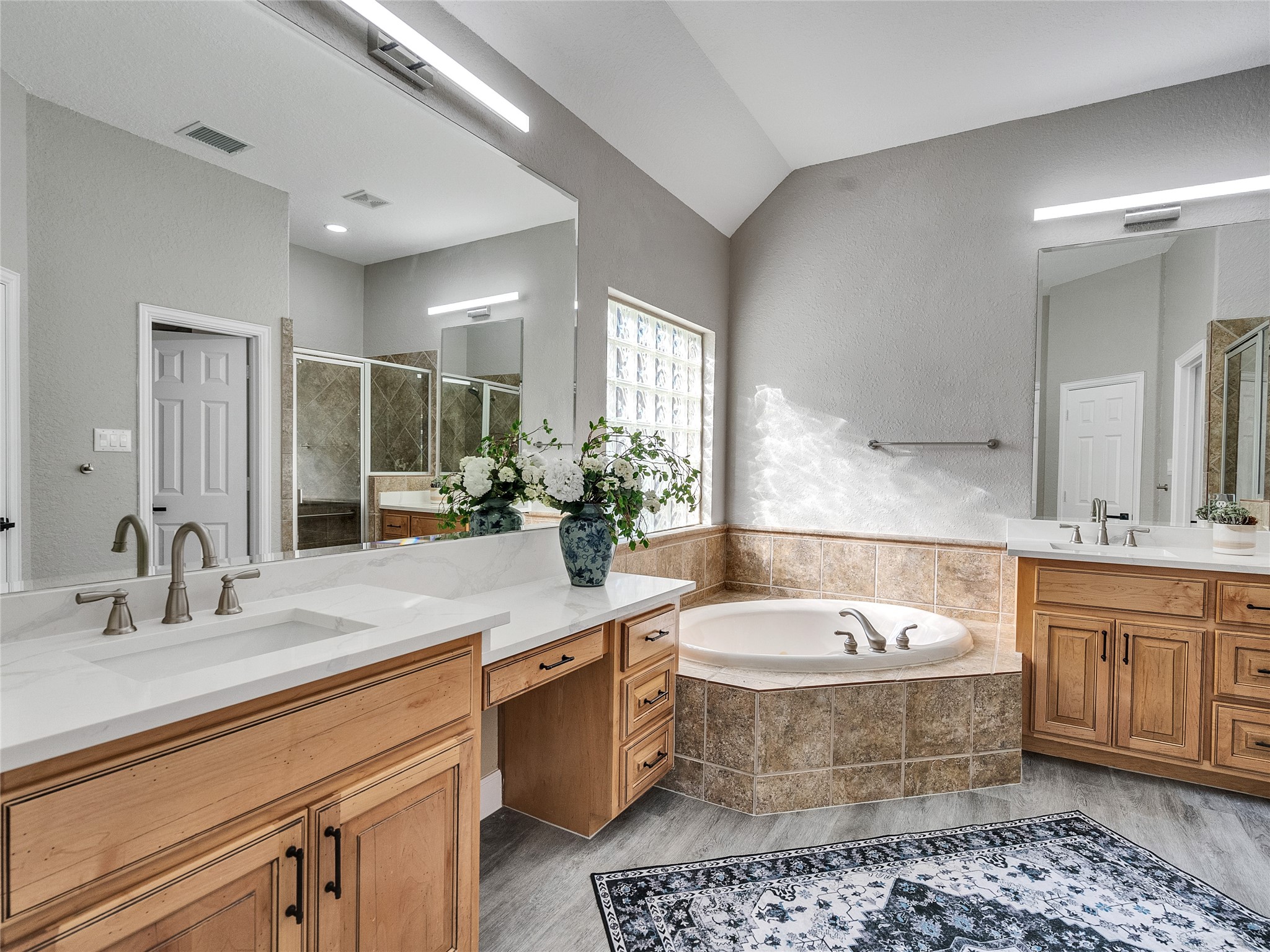 7218 Spring Meadow Lane Katy, TX 77494 - Photo 18 of 30 a bathroom with a double vanity sink a mirror and bathtub