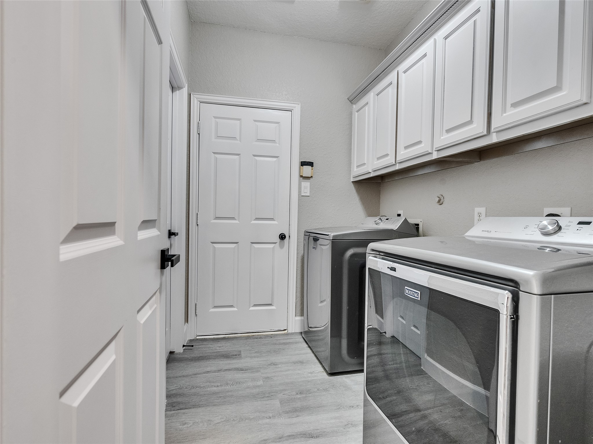 7218 Spring Meadow Lane Katy, TX 77494 - Photo 20 of 30 a utility room with cabinets washer and dryer