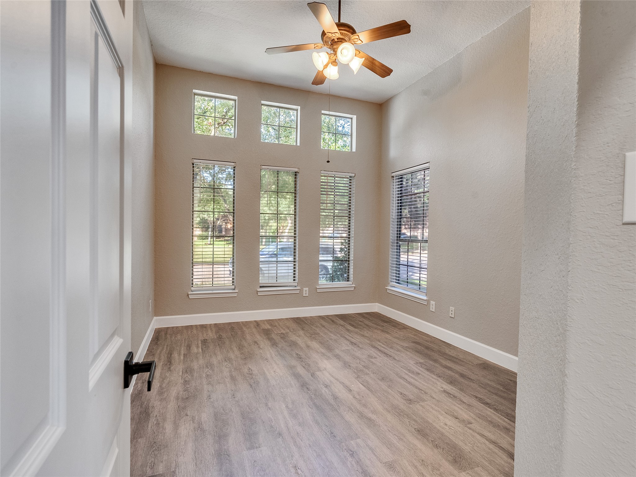 7218 Spring Meadow Lane Katy, TX 77494 - Photo 21 of 30 a view of an empty room with a window and wooden floor