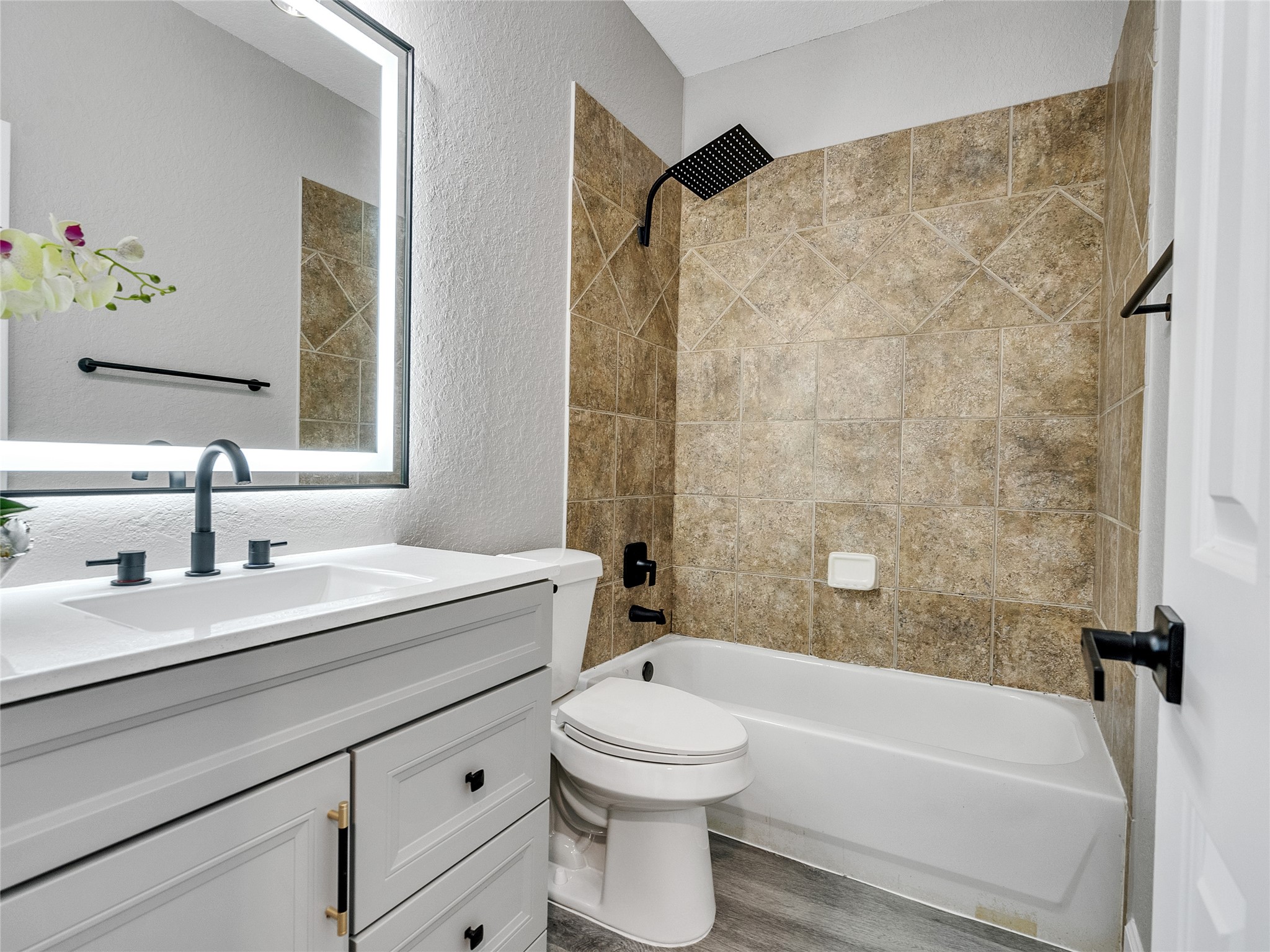 7218 Spring Meadow Lane Katy, TX 77494 - Photo 22 of 30 a bathroom with a sink a toilet and a bathtub